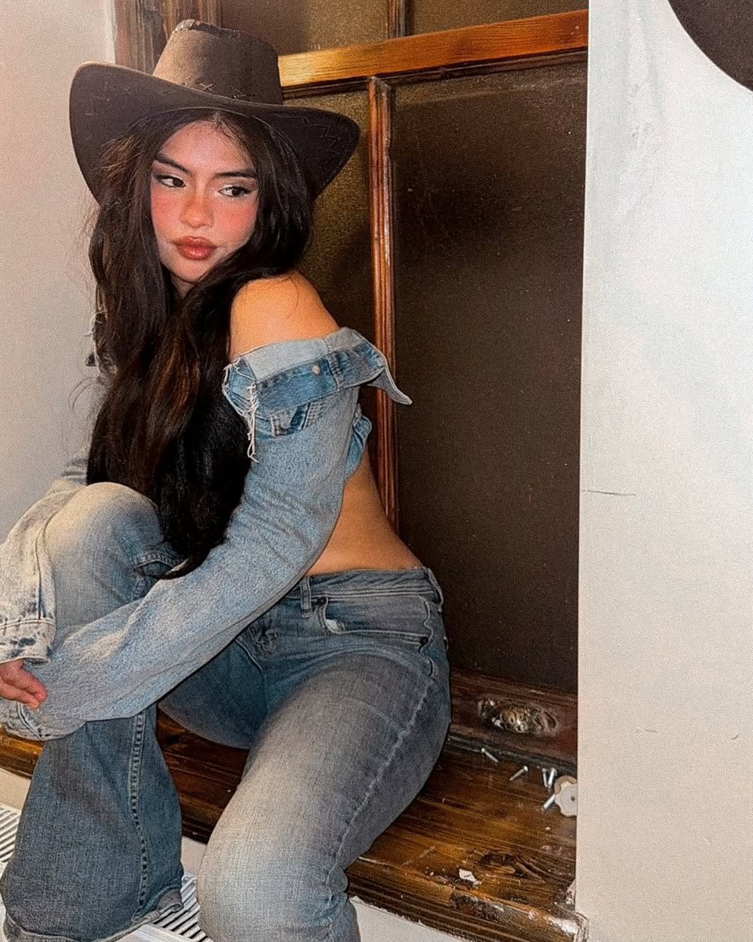 Mara posing in a cowgirl-inspired outfit