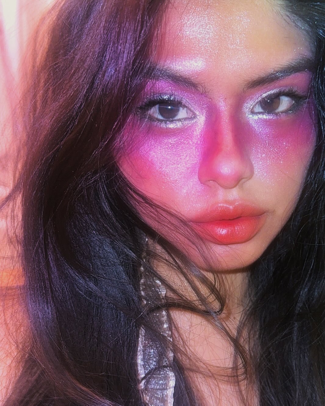 Close portrait of Mara in pink glitter light